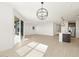 Open living room and kitchen with hardwood floors at 36833 W La Paz St, Maricopa, AZ 85138