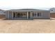 Home exterior with a covered patio and expansive, undeveloped backyard space, ready for customization at 19964 W Marshall Ave, Litchfield Park, AZ 85340