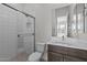 An ensuite bathroom featuring tiled shower, vanity with sink, and framed mirror at 19964 W Marshall Ave, Litchfield Park, AZ 85340