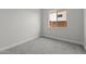 Bedroom with neutral walls, carpet, trim and window at 19964 W Marshall Ave, Litchfield Park, AZ 85340