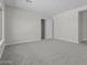 An airy bedroom featuring neutral walls, soft carpeting, and an interior door at 19964 W Marshall Ave, Litchfield Park, AZ 85340