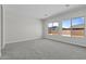Bright, carpeted bedroom with a neutral palette and two windows offering natural light and views at 19964 W Marshall Ave, Litchfield Park, AZ 85340