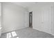 Bright, carpeted bedroom with white walls and trim, offering a serene and minimalist aesthetic at 19964 W Marshall Ave, Litchfield Park, AZ 85340