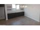 Dining area with storage, granite counters, and a modern chandelier at 19964 W Marshall Ave, Litchfield Park, AZ 85340