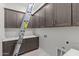 Functional laundry room with cabinets, folding counter, and ample storage space at 19964 W Marshall Ave, Litchfield Park, AZ 85340