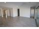 Spacious living room with a neutral color palette and tile flooring throughout at 19964 W Marshall Ave, Litchfield Park, AZ 85340