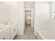 Spacious bathroom with double vanity, large walk-in closet, and bathtub at 37422 W San Clemente St, Maricopa, AZ 85138