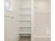 Bathroom featuring a bathtub, shelving, and linen storage at 37422 W San Clemente St, Maricopa, AZ 85138