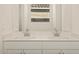Double vanity with modern fixtures in a bright bathroom at 37422 W San Clemente St, Maricopa, AZ 85138