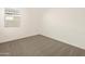 Well-lit bedroom featuring neutral carpeting and a window at 37422 W San Clemente St, Maricopa, AZ 85138