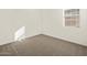Spacious bedroom with neutral carpeting and large window at 37422 W San Clemente St, Maricopa, AZ 85138