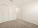 Spacious bedroom with double door closet and access to hallway at 37422 W San Clemente St, Maricopa, AZ 85138