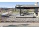 Outdoor kitchen area with grills and fireplace at 37422 W San Clemente St, Maricopa, AZ 85138