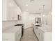 Modern kitchen with white cabinets, stainless steel appliances, and an island at 37422 W San Clemente St, Maricopa, AZ 85138