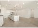 Open concept kitchen with island and modern chandelier at 37422 W San Clemente St, Maricopa, AZ 85138