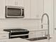 Sleek kitchen with stainless steel appliances and white cabinetry at 37422 W San Clemente St, Maricopa, AZ 85138