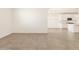 Open living room with kitchen view and tile floor at 37422 W San Clemente St, Maricopa, AZ 85138