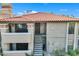 View of condo building with Spanish-style architecture and staircase at 7557 N Dreamy Draw Dr # 251, Phoenix, AZ 85020