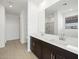 Double vanity bathroom with dark cabinets and a large mirror at 37501 W San Clemente St, Maricopa, AZ 85138