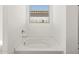 Bathroom featuring a corner soaking tub and window at 37501 W San Clemente St, Maricopa, AZ 85138