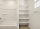 Clean bathroom with a shower/tub combo, shelving, and tile floor at 37501 W San Clemente St, Maricopa, AZ 85138