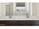 Double sink bathroom vanity with modern chrome faucets at 37501 W San Clemente St, Maricopa, AZ 85138