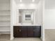 Double vanity bathroom with a large mirror and built-in shelving at 37501 W San Clemente St, Maricopa, AZ 85138