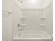 Clean bathroom with shower/tub combo and built in shelving at 37501 W San Clemente St, Maricopa, AZ 85138