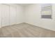 Bright bedroom featuring neutral carpeting and double-door closet at 37501 W San Clemente St, Maricopa, AZ 85138