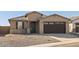 Single-story house with a two-car garage and rock landscaping at 37501 W San Clemente St, Maricopa, AZ 85138