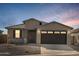 Single-story home with a two-car garage and desert landscaping at 37501 W San Clemente St, Maricopa, AZ 85138