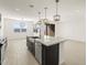 Modern kitchen with an island and stainless steel appliances at 37501 W San Clemente St, Maricopa, AZ 85138