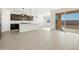 Open concept kitchen with island, stainless steel appliances, and access to backyard at 37501 W San Clemente St, Maricopa, AZ 85138