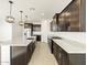 Open concept kitchen with island and stainless steel appliances at 37501 W San Clemente St, Maricopa, AZ 85138
