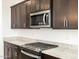 Modern kitchen with stainless steel appliances and granite countertops at 37501 W San Clemente St, Maricopa, AZ 85138