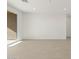 Spacious living room with sliding glass doors and light flooring at 37501 W San Clemente St, Maricopa, AZ 85138