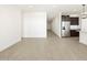 Spacious living room with tile floors and access to kitchen at 37501 W San Clemente St, Maricopa, AZ 85138