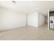 Open living room with tile flooring and neutral walls at 37501 W San Clemente St, Maricopa, AZ 85138