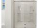 Large walk-in shower with glass enclosure and built-in shelves at 37501 W San Clemente St, Maricopa, AZ 85138