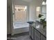 Bathroom featuring a soaking tub with a tile backsplash and granite countertops at 6623 N 85Th Ave, Glendale, AZ 85305