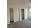 Bedroom featuring two large closets with sliding doors, carpet, ceiling fan, and a window at 6623 N 85Th Ave, Glendale, AZ 85305