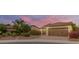 Beautiful desert home exterior with landscaped yard and two-car garage at 12368 W Running Deer Trl, Peoria, AZ 85383