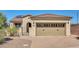Single story home with tan exterior and two-car garage at 12368 W Running Deer Trl, Peoria, AZ 85383