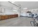 Garage with workbench, cabinets, and storage shelving at 12368 W Running Deer Trl, Peoria, AZ 85383