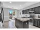 Eat-in kitchen with island, stainless steel appliances and access to a patio at 12368 W Running Deer Trl, Peoria, AZ 85383