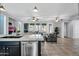 Modern kitchen with dark cabinets and expansive island at 12368 W Running Deer Trl, Peoria, AZ 85383