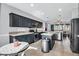 Modern kitchen featuring dark cabinetry and an island at 12368 W Running Deer Trl, Peoria, AZ 85383