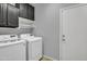 Laundry room with washer, dryer, and cabinets at 12368 W Running Deer Trl, Peoria, AZ 85383