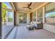 Covered patio with tiled floor, seating, and ceiling fan at 12368 W Running Deer Trl, Peoria, AZ 85383