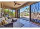 Relaxing covered patio with seating area, offering views of the backyard and pool at 12368 W Running Deer Trl, Peoria, AZ 85383